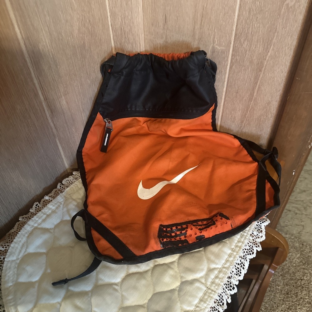 Nike Brasilia 9.5 Training Gym Sack featuring a vibrant orange White Swoosh
